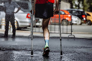 Adult with an ambulant disability using crutches