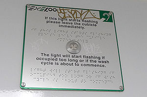 Braille and tactile signage at ceiling enlarged
